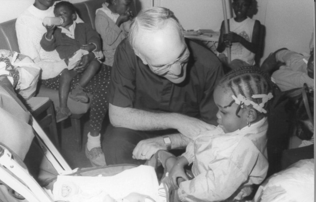 Paul Johnson engaging with a family in Camillus House's former shelter on NE 1st Avenue and 8th street.