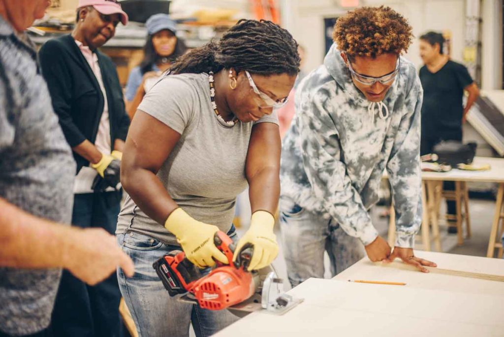 FIU Graduate operating a saw